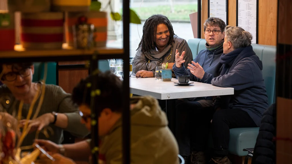 Three people having coffee and talking