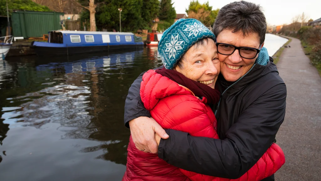 Two women smiling and hugging