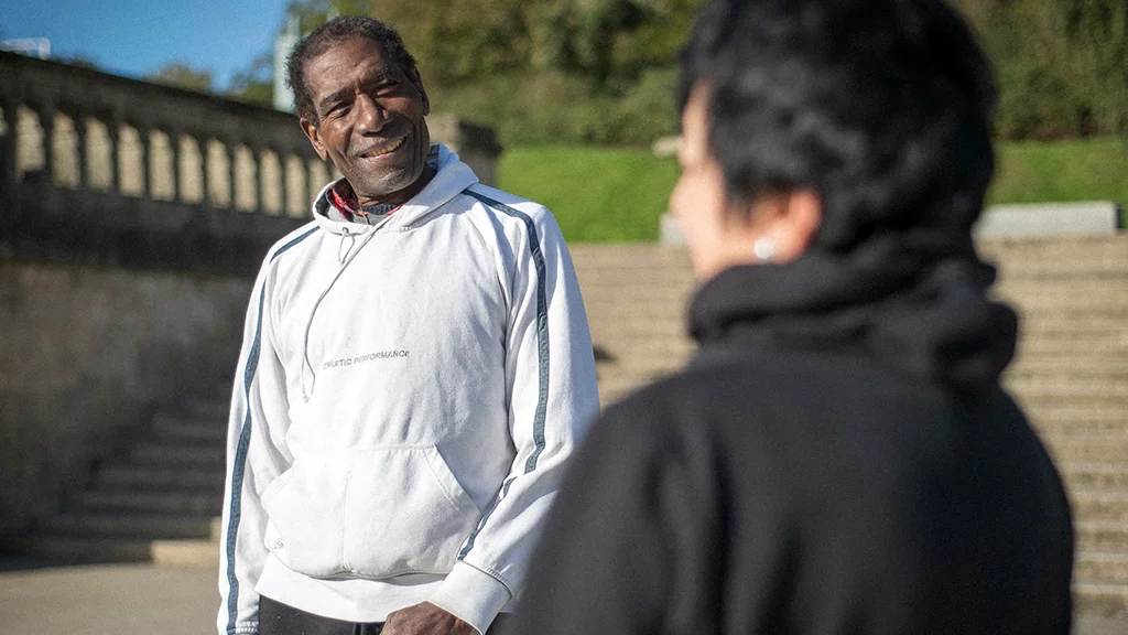 Two older people outside socialising