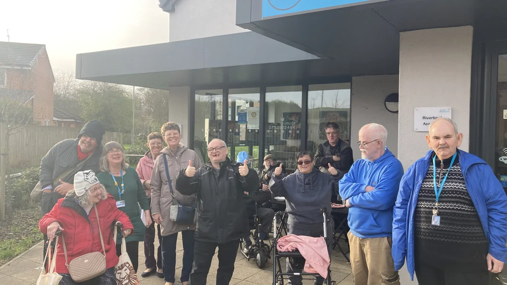 A large group of people outside a community space